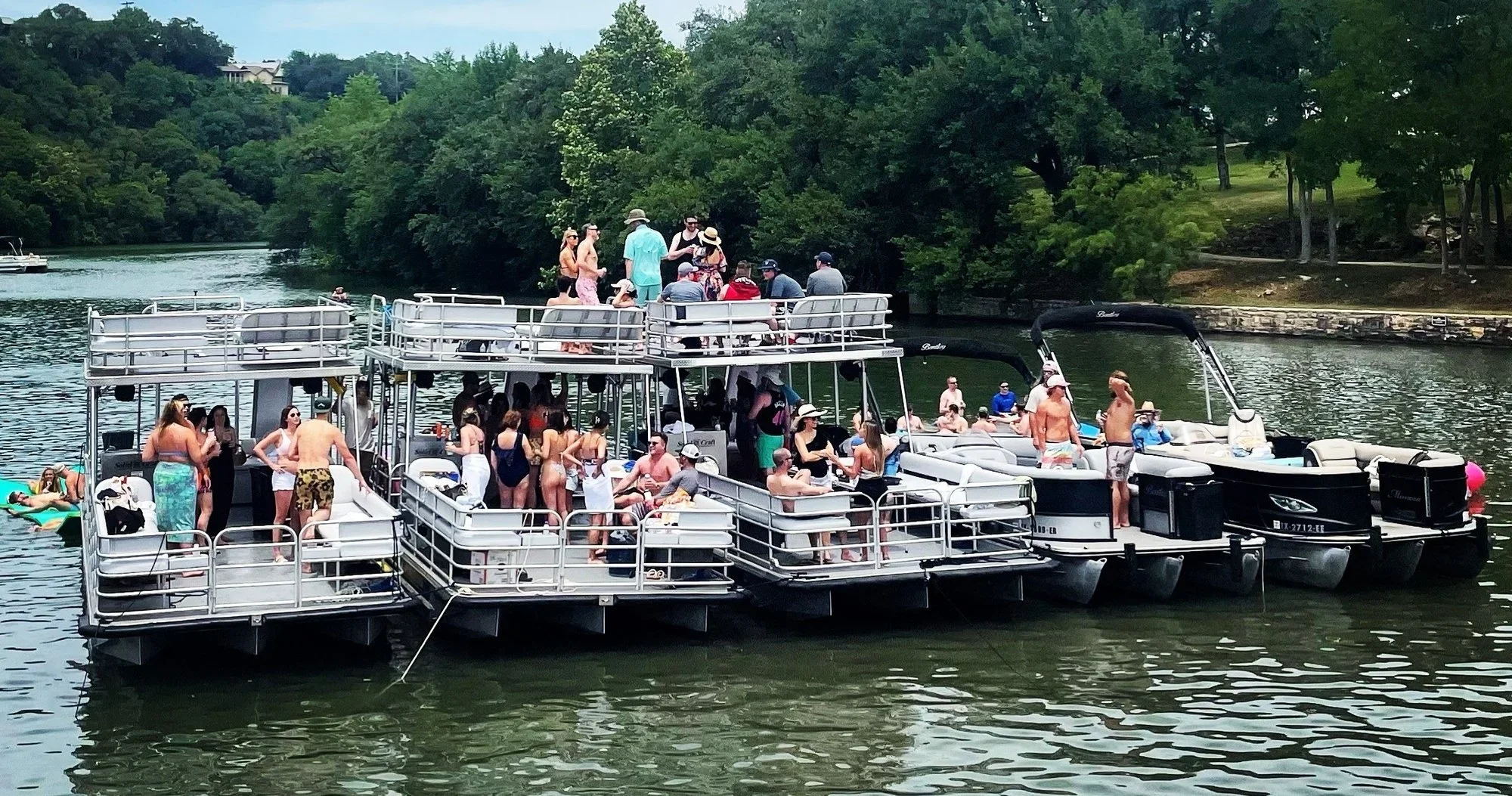 Lake Austin double decker boat rental anchored for a group lake day