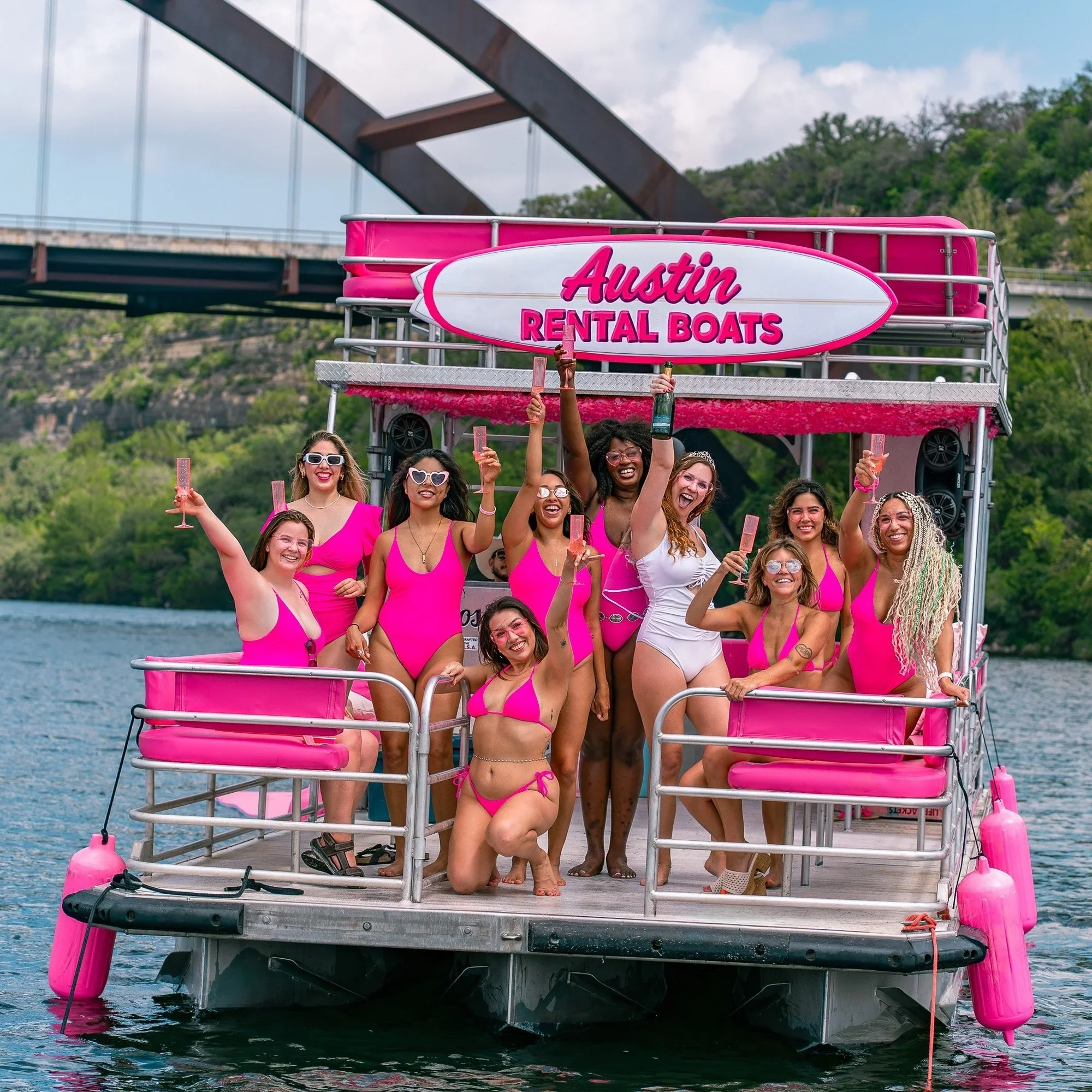 Austin bachelorette group on a pink Lake Austin double decker boat